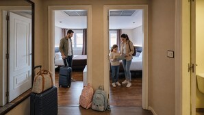 A hotel room with a bed, a window, and a door. There are suitcases and a backpack on the floor. - Hotel Mogay (Chantada)