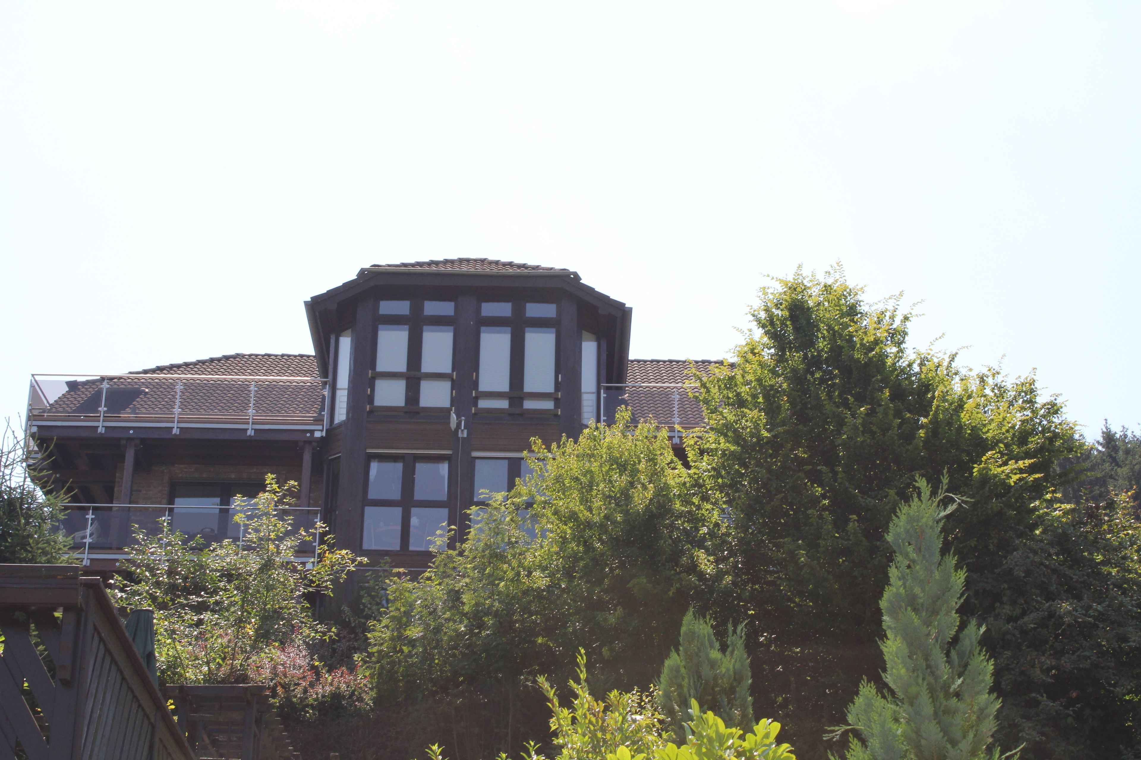 A two-story building with a prominent central tower and multiple windows.