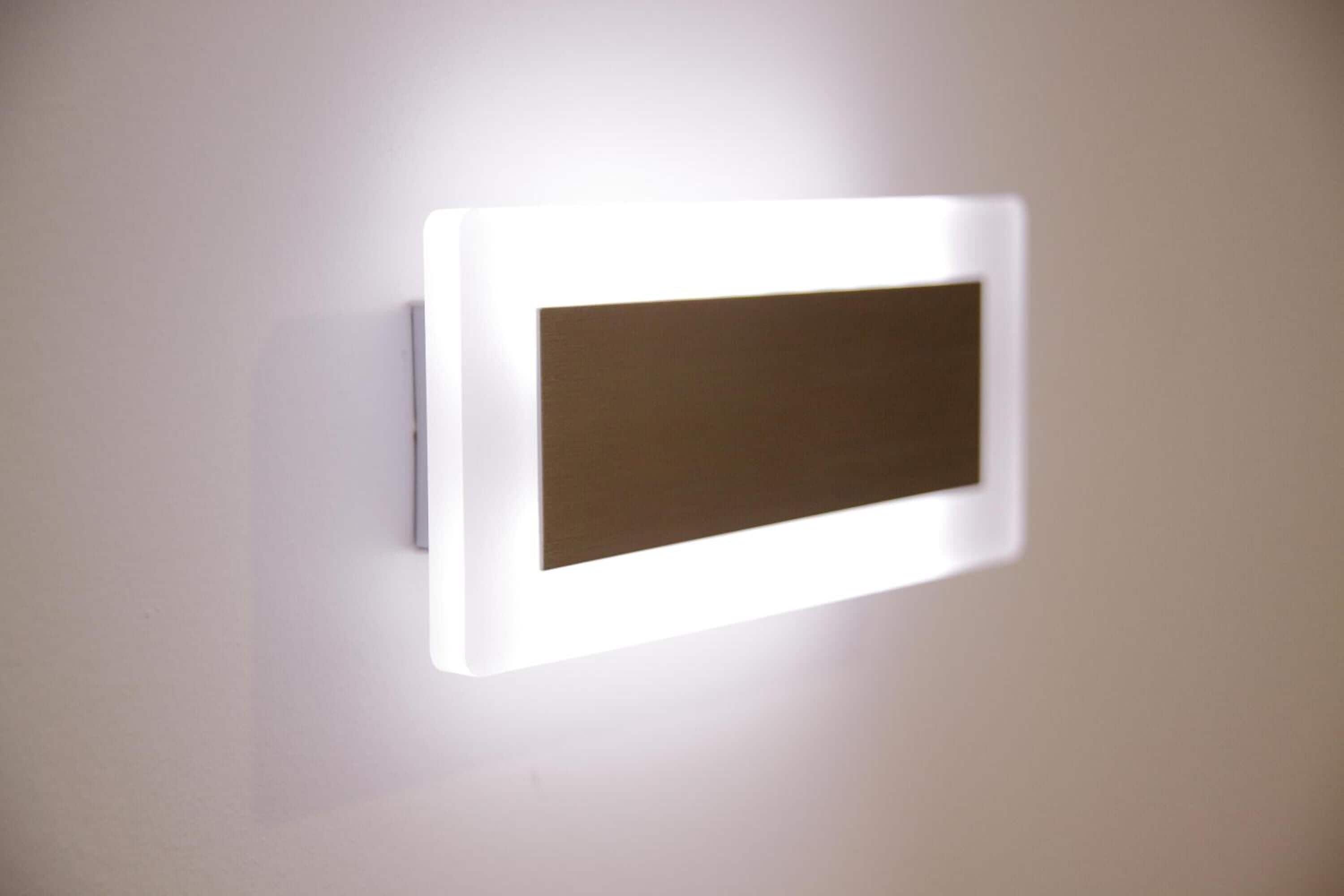 A wall-mounted light fixture with a rectangular light panel.