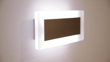 A wall-mounted light fixture with a rectangular light panel.