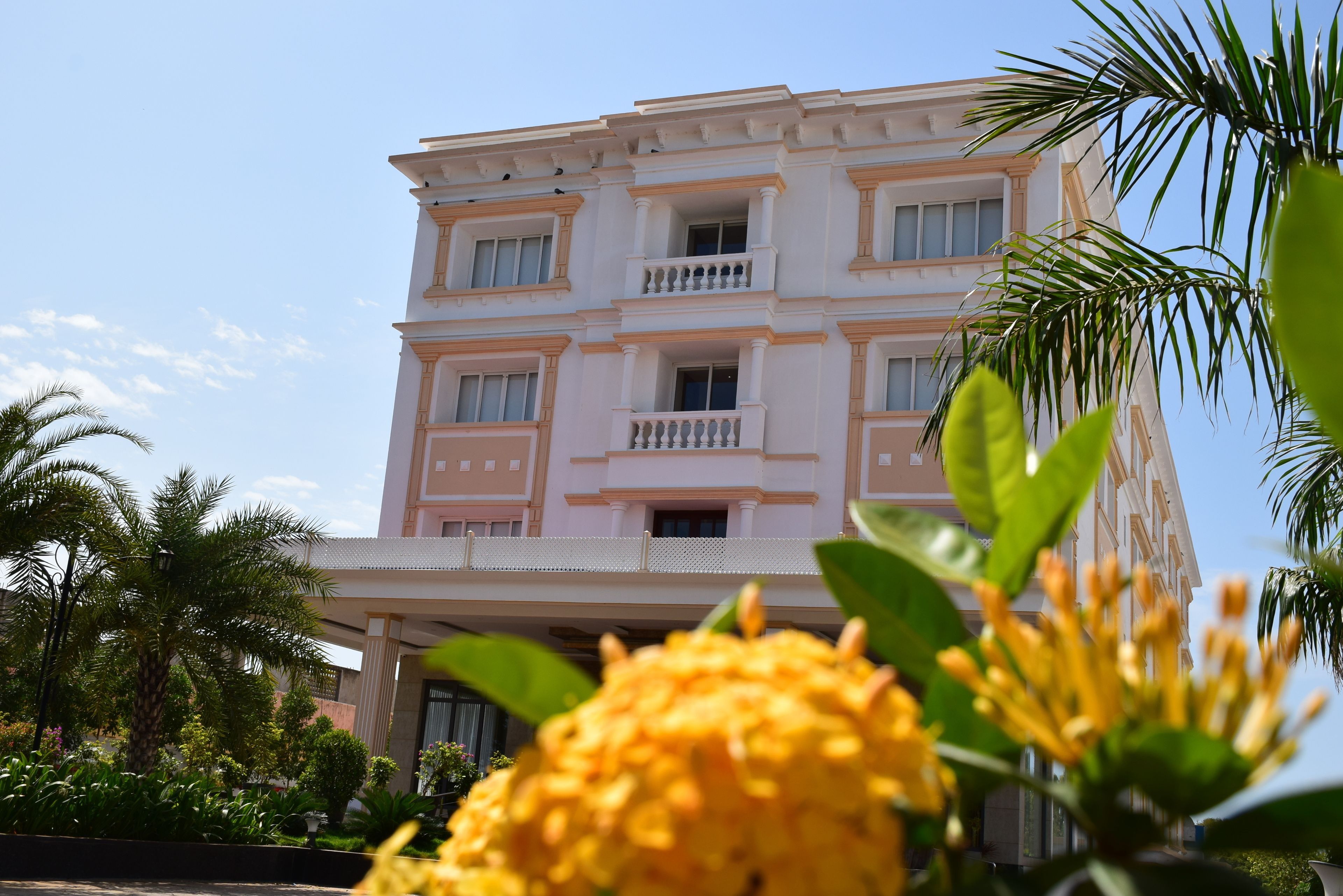A multi-story hotel with balconies and a flat roof.