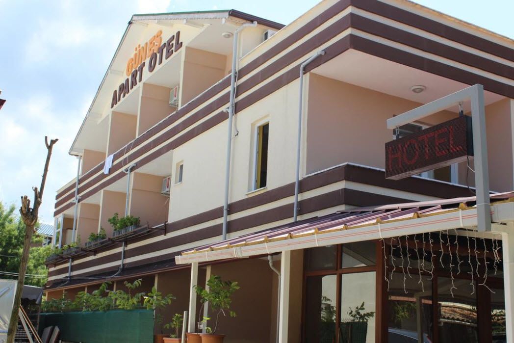 A hotel with a sign indicating it is an apartment hotel.