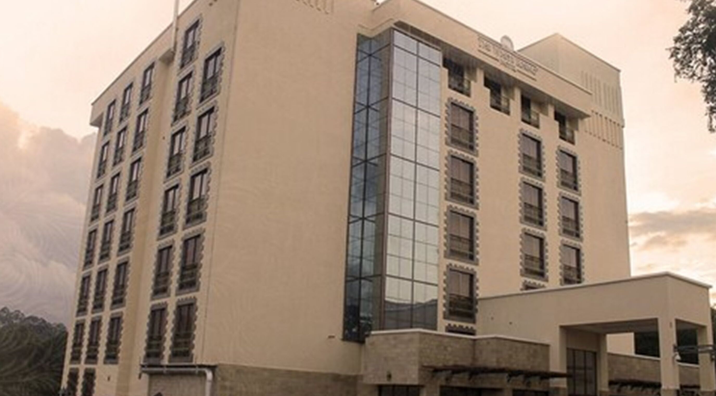 A multi-story hotel with a modern facade, large windows, and a prominent entrance.