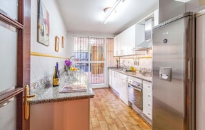 Fridge, stovetop, dishwasher, coffee/tea maker