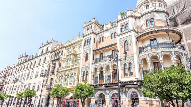 A historic building with ornate facades, multiple balconies, and a dome structure.