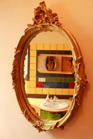 A bathroom with a mirror, sink, and tiled walls. - Spirit Lodge Leipzig - Hostel (Leipzig)