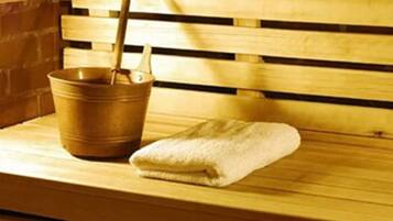 A wooden bench with a metal bucket and a towel placed on it.