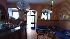 A cozy living area with a blue sofa, a wooden coffee table, and a tiled floor. - Caterina House (San Lucido)