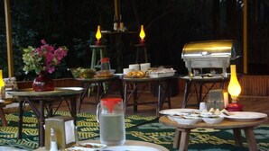 An outdoor dining area with tables, chairs, and a grill. - Likya Lodge Adrasan (Kumluca)