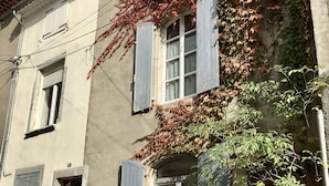 A building with multiple windows, some with shutters, and a door. - Les Asphodeles (Saint-Hippolyte-du-Fort)