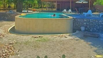 A waterfall pool, pool loungers