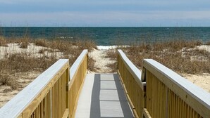 A wooden boardwalk leading to the beach with sand and sparse vegetation. - 9/19-26 WOW SALE! Oceanfront House, 4-7 Night Stay, WEEKLY DEAL, Walk to Pier! (Kure Beach)
