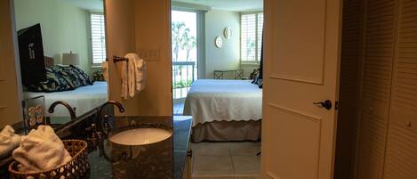 A bathroom with a sink, mirror, and towel rack.