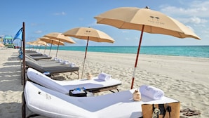 A beachside hotel with sun loungers, beach umbrellas, and a clear view of the ocean. - Setai (Miami Beach)