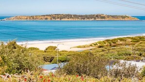 A coastal landscape with a beach, a small island, and a pier. - Oceanfront Haven with Unparalleled Views and Retreat Living (Victor Harbor)