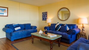 A living room with two blue sofas, a wooden coffee table, and two lamps. - Oceanfront Haven with Unparalleled Views and Retreat Living (Victor Harbor)