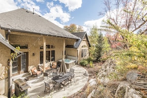Relax in the patio area with a hot tub and outdoor furniture.