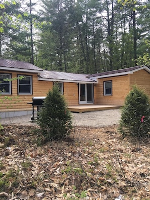 Side of house with porch area and fire pit