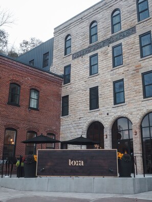 A building with a stone facade and a sign that reads "LOSA". - Lora (Stillwater)