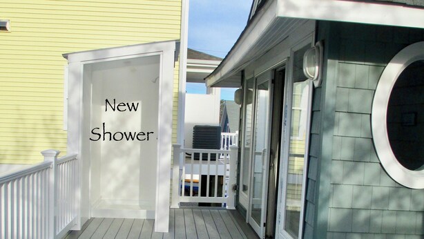 A deck with new railings and a new shower. - LAVALLETTE New Panoramic Deck, Outdoor shower, and Kitchen INCLUDES BEACH BADGES (Lavallette)