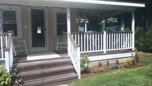A house with a porch, steps, and a mailbox.