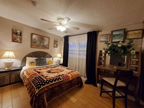 A hotel room with a bed, two bedside lamps, a ceiling fan, a dining table with chairs, and artwork on the walls. - 🌴 Escape in a private pool, jacuzzi, bbq, koi pond, garden, best outdoor area! (Las Vegas)