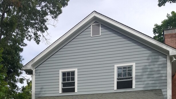 A two-story house with a front porch, a garage, and a well-maintained lawn. - Sag Harbor Village Gem (Sag Harbor)