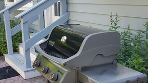 A portable gas grill with a digital display, placed on a paved patio. - Sag Harbor Village Gem (Sag Harbor)