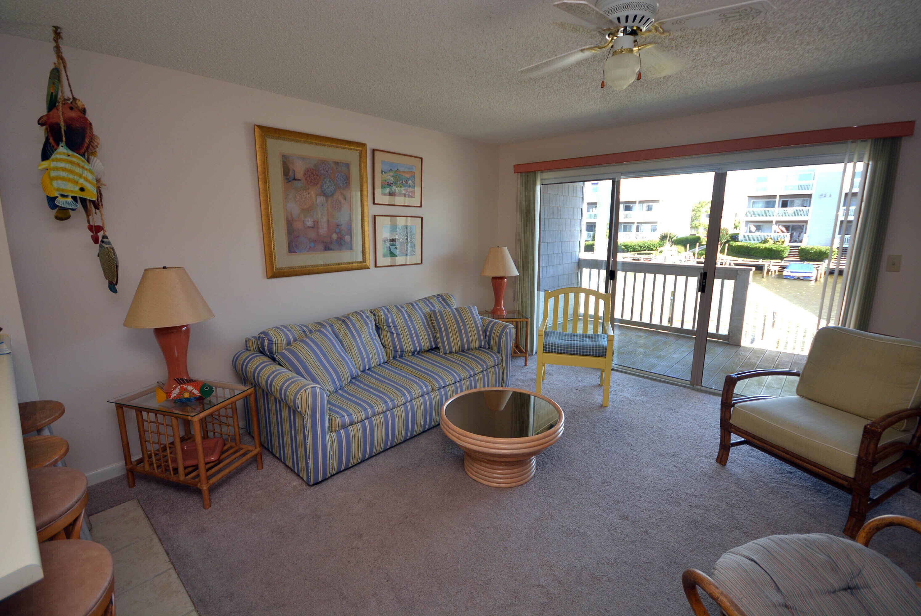 Cozy, inviting 1 bedroom condo with an outdoor pool and gorgeous canal-front view located uptown on the bayside just a few blocks from the beach!