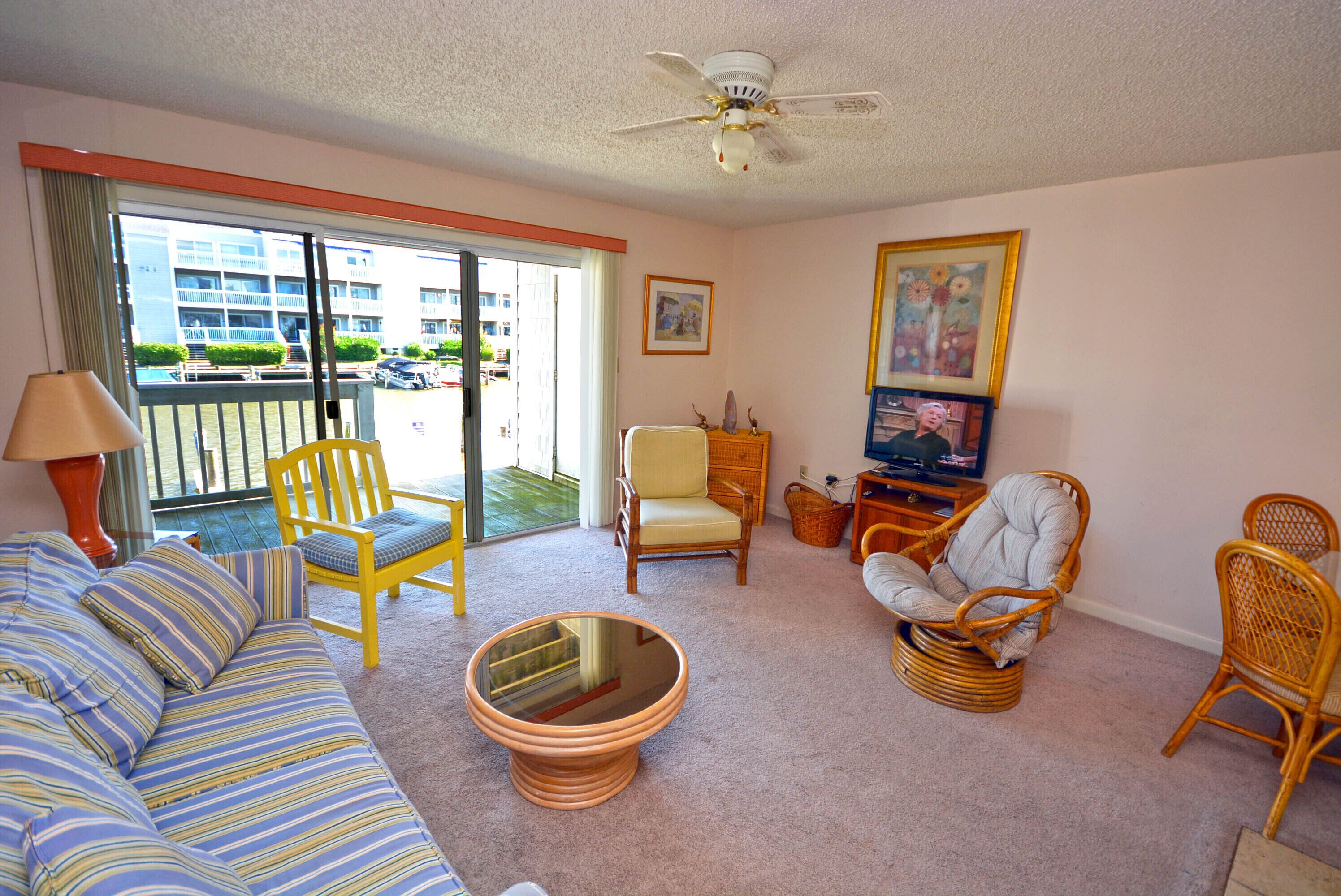 Cozy, inviting 1 bedroom condo with an outdoor pool and gorgeous canal-front view located uptown on the bayside just a few blocks from the beach!