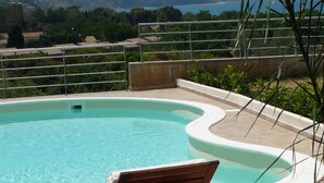A swimming pool with a view of a distant coastline and hills. - Townhouse with stunning view, only 5 minutes walk to the beach (Vibo Valentia)