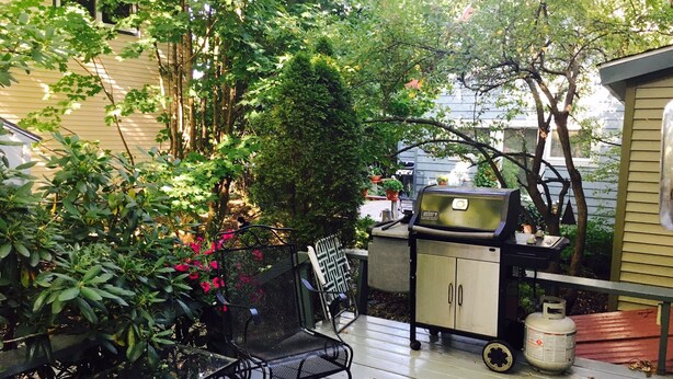 A patio with a grill, a metal table, and chairs. - Locally owned downtown home:  Bar Harbors Crows' Nest (Bar Harbor)