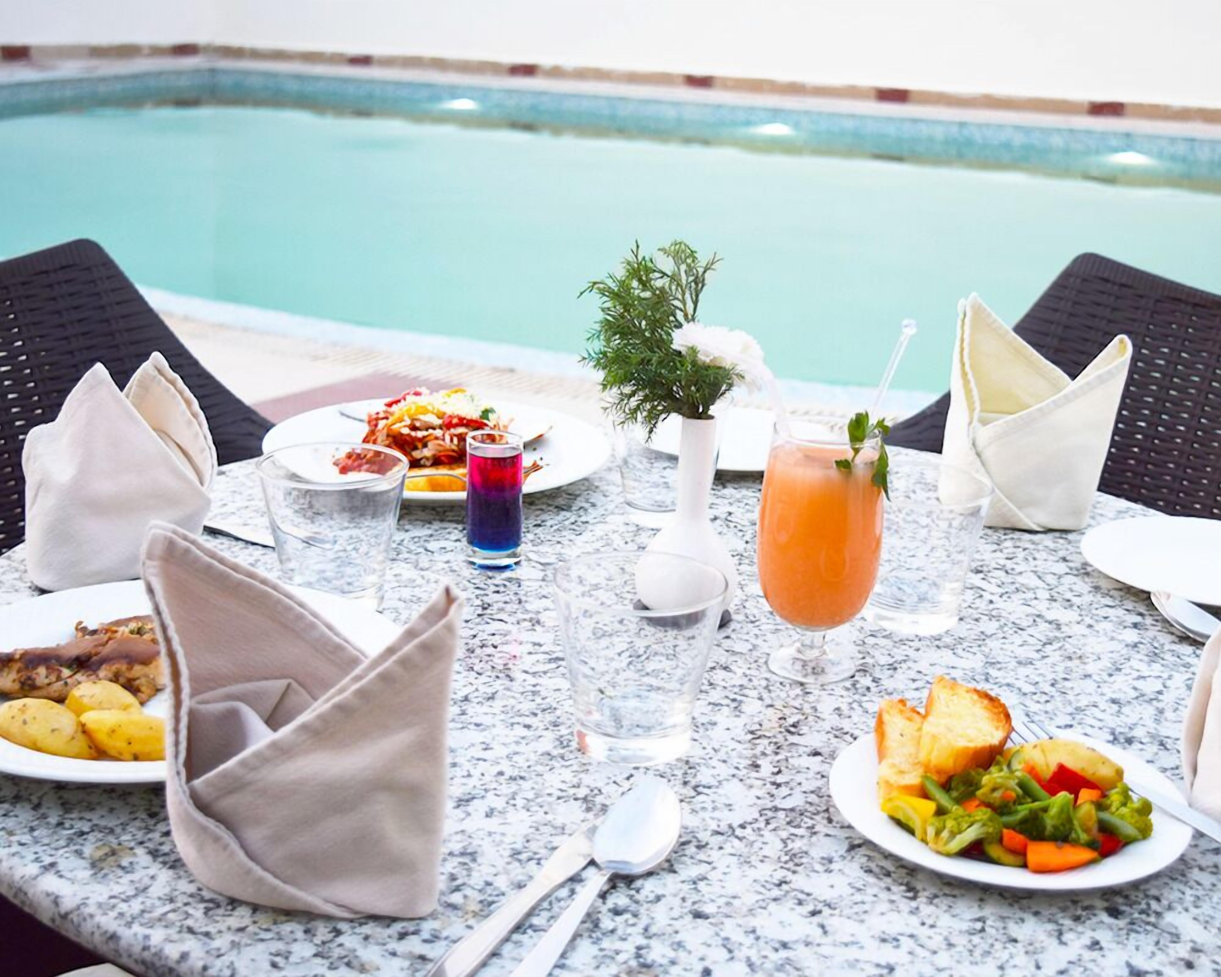 Seasonal outdoor pool, open 7 AM to 6:30 PM, pool umbrellas