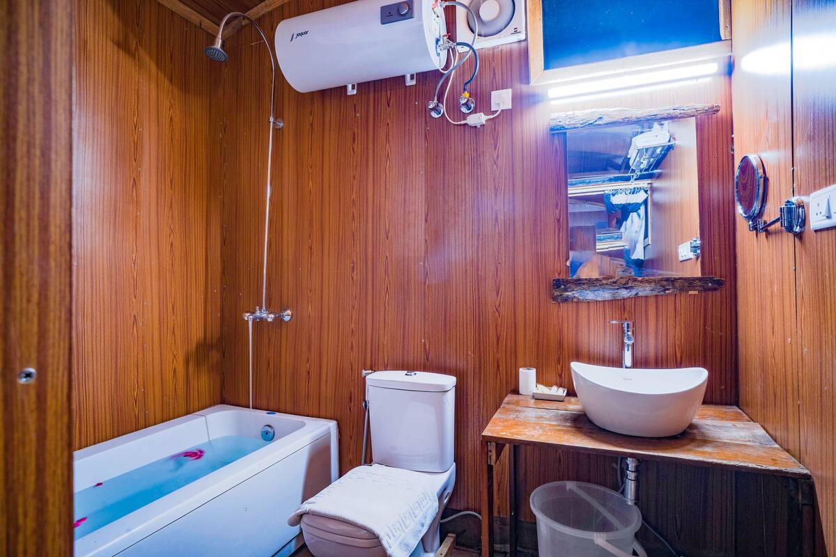 shepherd huts (honeymoon suite) | bathroom | eco-friendly toiletries, bathrobes, bidet, heated floors