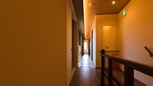 A long, narrow hallway with wooden flooring and a wooden handrail on the right. - KumoMachiya Suieikaku (Kyoto)