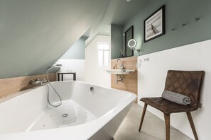 Bathtub, hair dryer, towels, soap