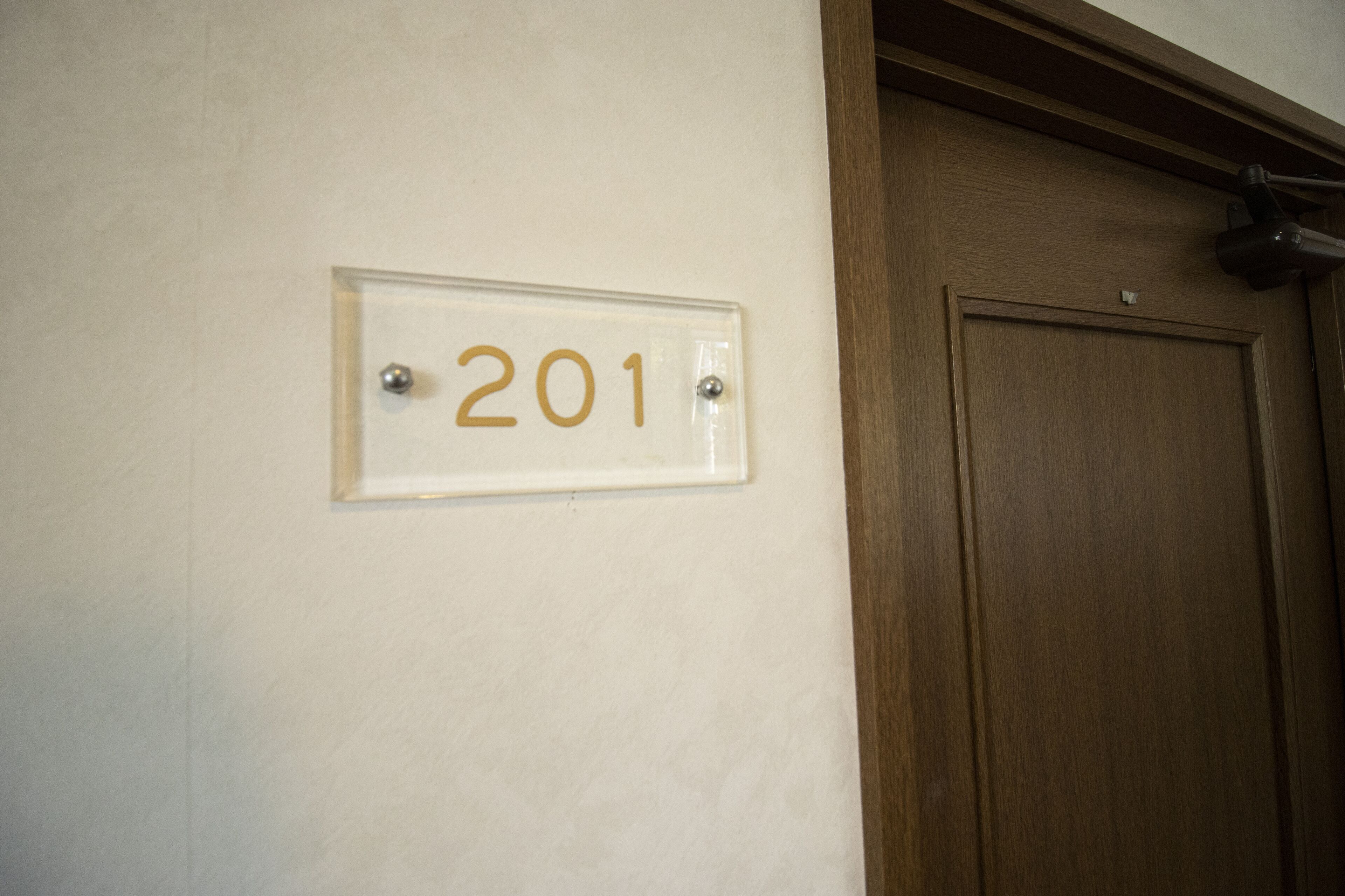 A room number sign, 201, mounted on a wall.