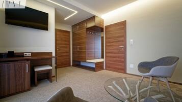 A modern room with a wooden wardrobe, a glass table, and a chair.