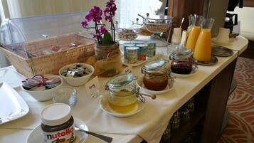 A breakfast buffet with various food items and condiments.
