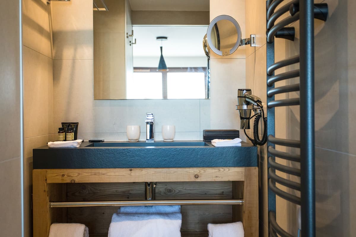 designer toiletries, hair dryer, bathrobes, slippers