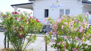 A white building with a sign reading "Felix Beach" and a covered porch.