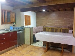 A compact kitchen with a sink, cabinets, and a small countertop.