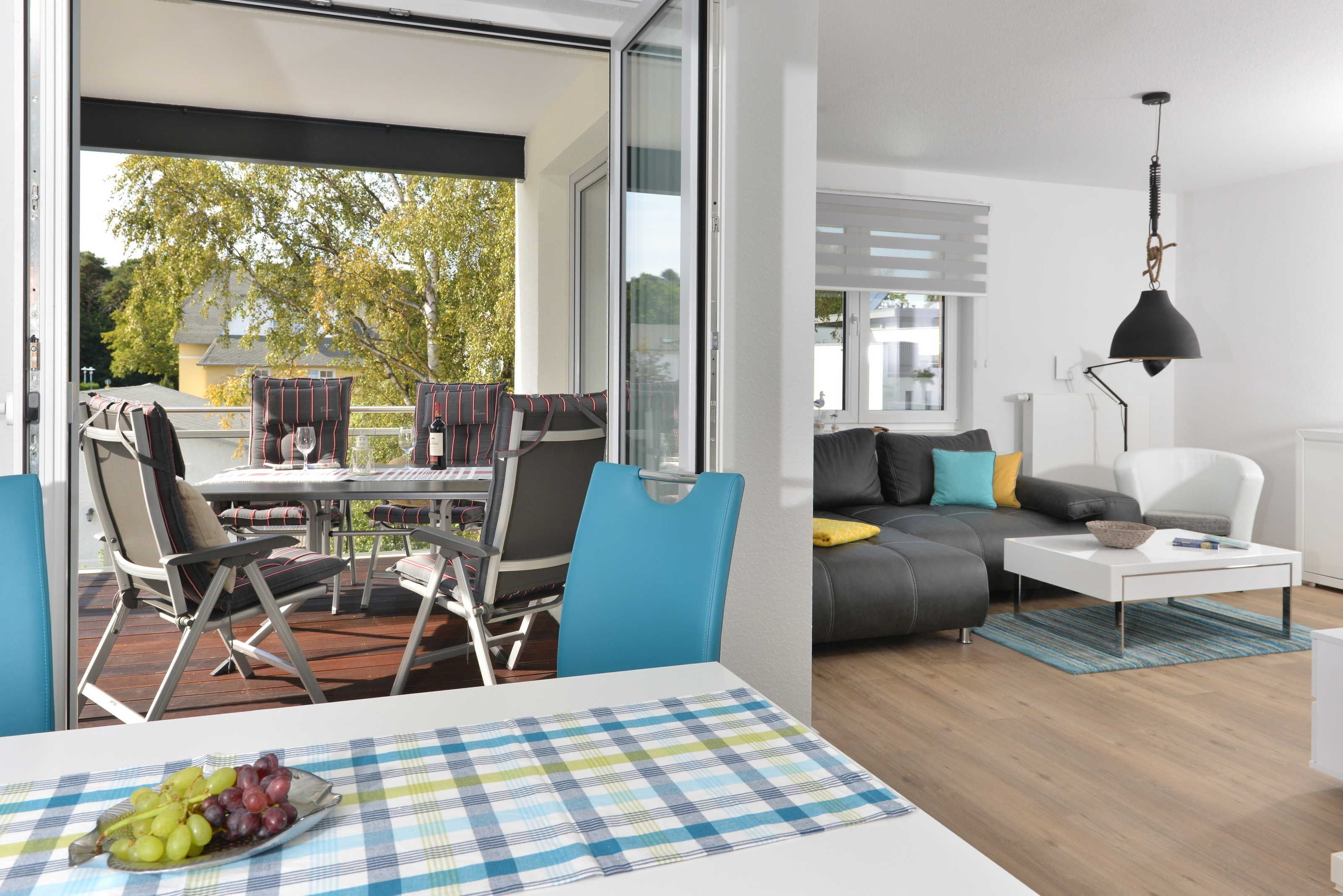 A modern living room with a dining area, a sofa, and a coffee table.