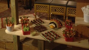 A buffet table with various food items and bottles of wine. - Les Milles et une Nuits (Sisco)