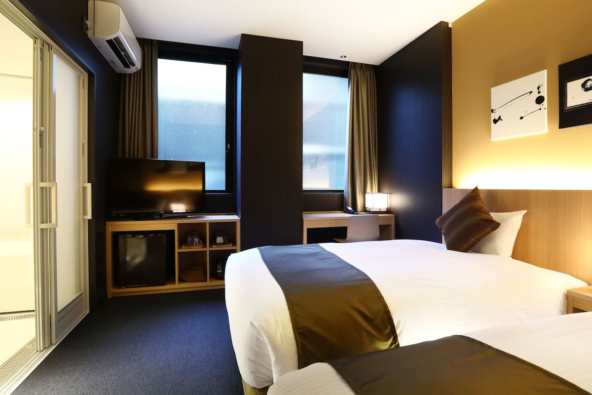 Universal Twin Room | Down comforters, memory foam beds, individually decorated