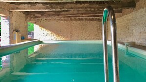 An indoor swimming pool with a wooden deck and metal handrails. - Luxury Cottage, Outdoor Nordic Hot Tub and Sauna, D-Day Beaches 15 km (Isigny-Sur-Mer)