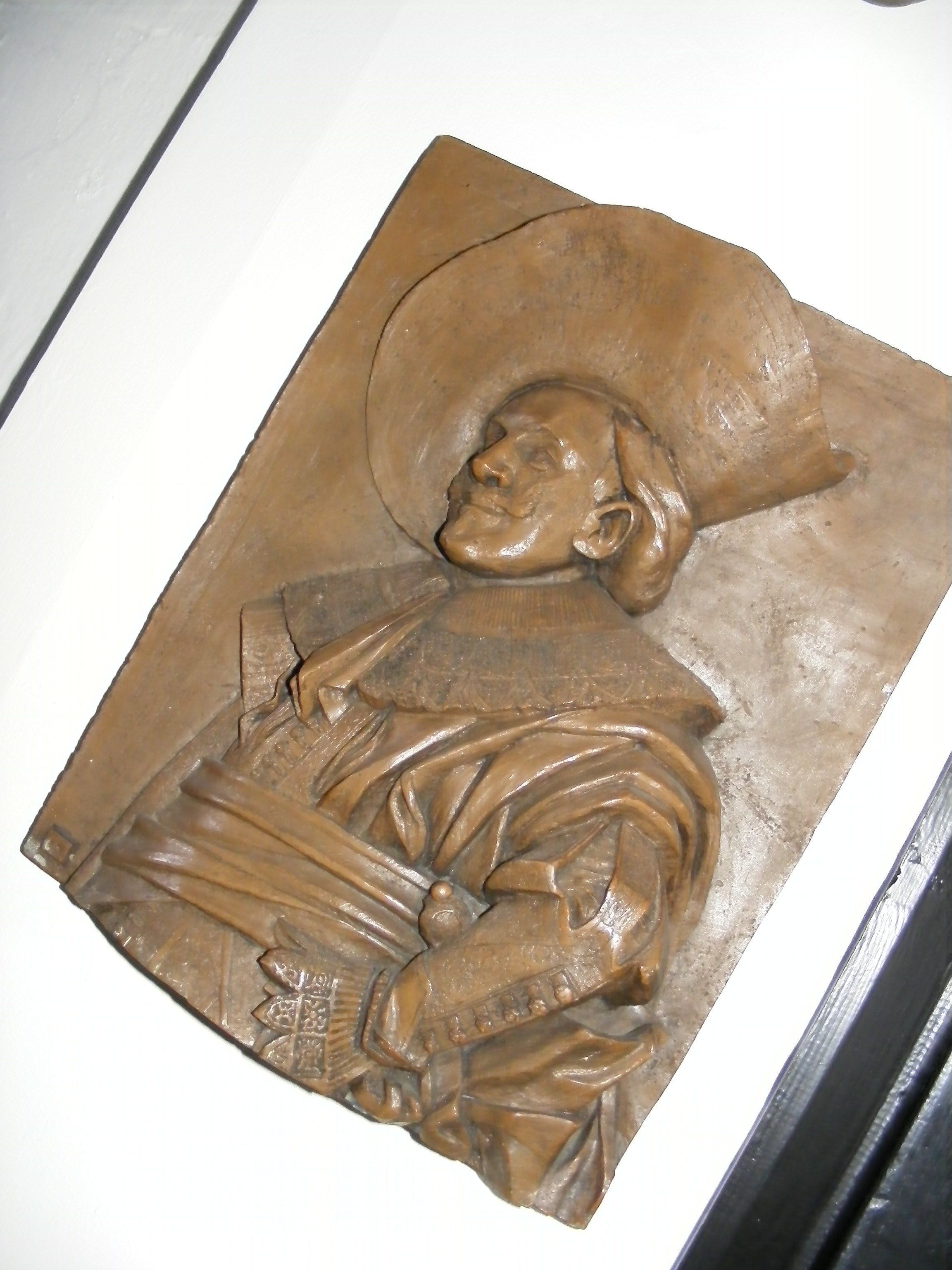 A sculpture of a person in traditional attire, possibly a historical or cultural artifact.
