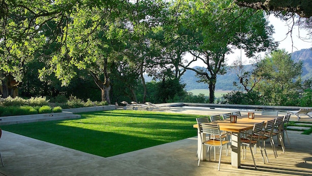 An outdoor patio with a dining table and chairs, surrounded by lush greenery and trees. - Private Wine Country Estate with Panoramic Views, Tennis Court - TOT Cert 450N (Kenwood)
