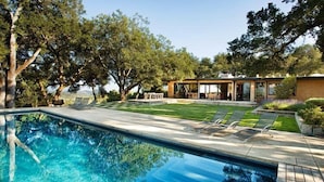 A swimming pool with clear blue water, surrounded by a wooden deck and lounge chairs. - Private Wine Country Estate with Panoramic Views, Tennis Court - TOT Cert 450N (Kenwood)
