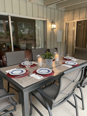 Enjoy al fresco dining in this beautifully set outdoor space with a long table for four, complete with comfortable seating and a lovely view.